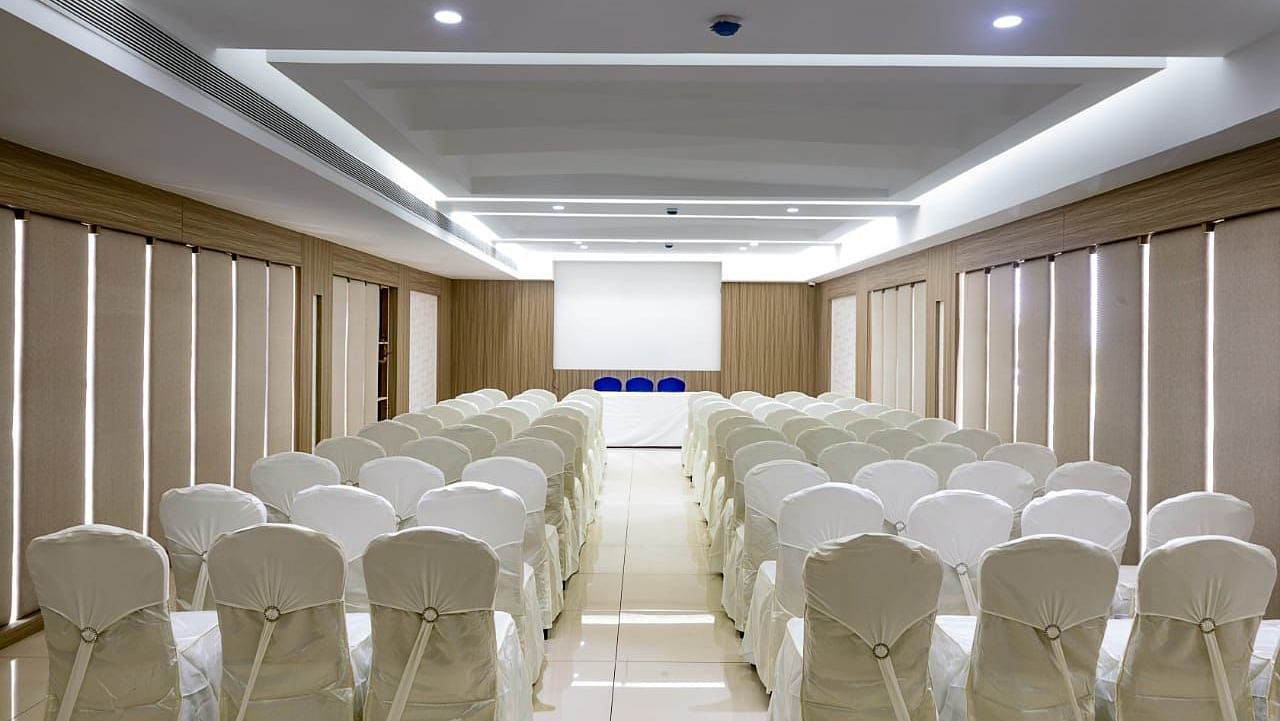 V Square Hall at Mayberry Tiruppur viewed from the back, featuring all chairs arranged neatly